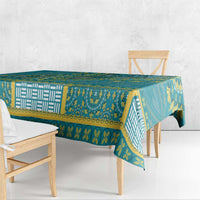 Teal dashiki tablecloth with bold yellow border, repeating symbols, and patterned panels