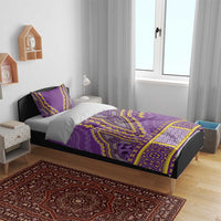 Purple dashiki bedding set with yellow geometric accents and two pillow shams on bed frame
