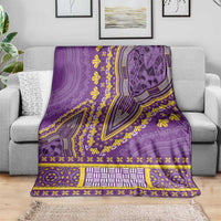Purple dashiki blanket laid on sofa with bold yellow floral motifs and striped band