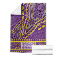Purple dashiki blanket folded, showing detailed medallion arch, floral sprigs, and trim