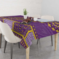 Purple dashiki tablecloth with geometric border and floral motifs, draped over table