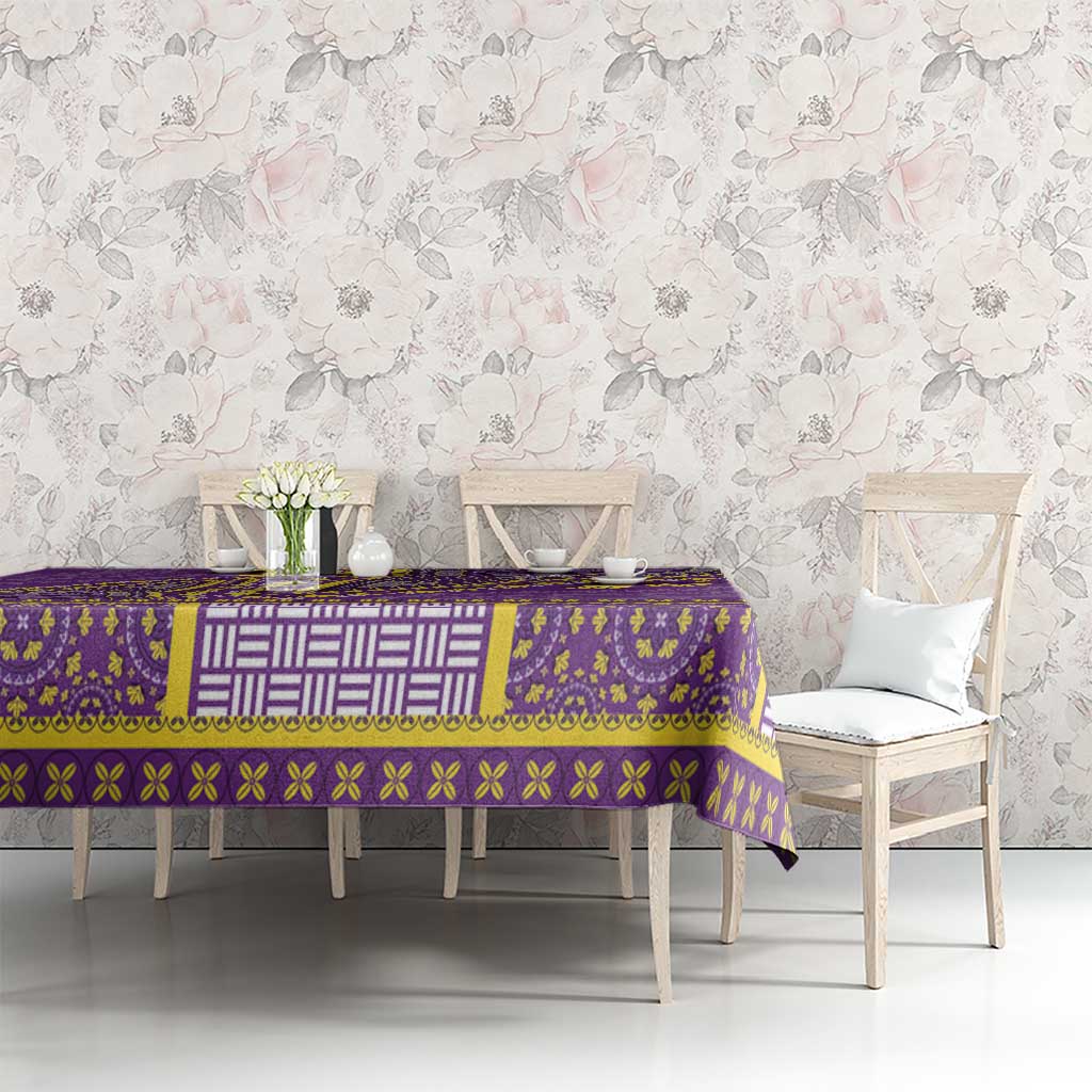 Purple dashiki tablecloth with gold and white ornamental border on dining table