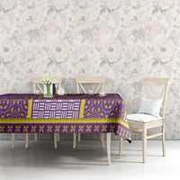 Purple dashiki tablecloth with gold and white ornamental border on dining table