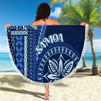 Round beach blanket with blue leaf emblem and 'SAMOA' text, framed by white fringe
