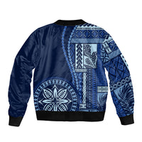 Unisex blue bomber jacket with large white floral and geometric patchwork, black ribbed hem