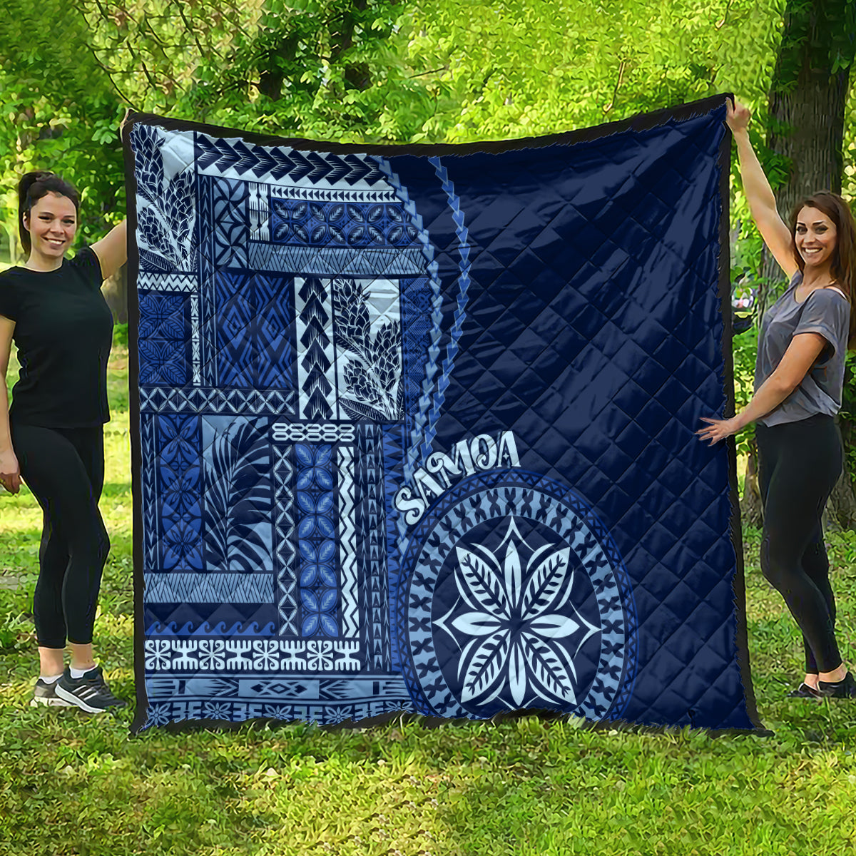 Navy blue quilt with Samoa siapo geometric patterns, quilted texture, and round floral motif