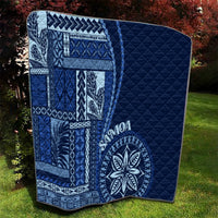 Navy blue quilt with Samoa siapo motifs and large round floral medallion, quilted side