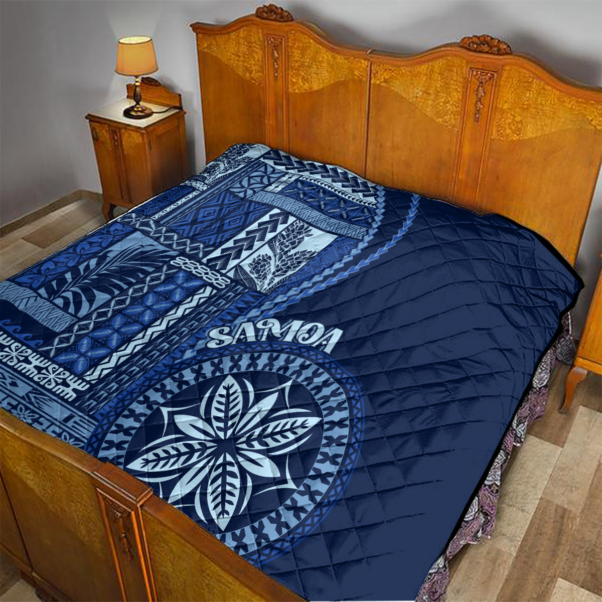 Navy blue and white quilted bedding cover with Samoa siapo panel and round floral design
