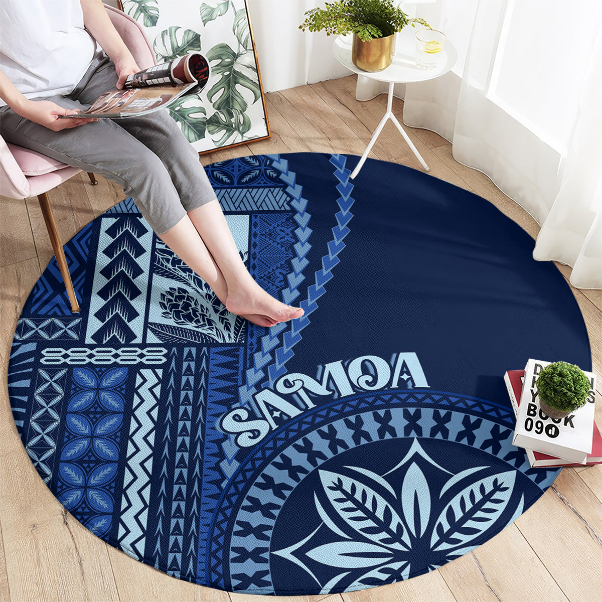 Round blue rug with bold white geometric motifs and leaf emblem, “Samoa” lettering