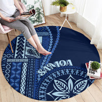 Round blue rug with bold white geometric motifs and leaf emblem, “Samoa” lettering
