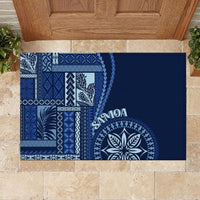 Blue rubber doormat with prominent siapo pattern corner and round leaf emblem