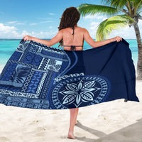 Navy blue siapo motif sarong draped on back, with circular emblem and arrow pattern