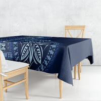 Blue patterned tablecloth draped on dining table, featuring leaf and geometric motifs
