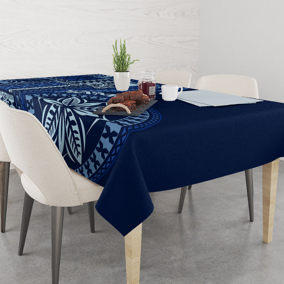 Blue tablecloth with bold leaf and island-style geometric prints, corner drape