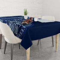 Blue tablecloth with bold leaf and island-style geometric prints, corner drape