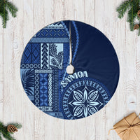 Blue patterned round tree skirt with geometric panels and leaf motif