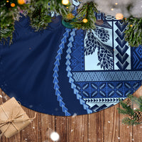 Blue circular tree skirt with bold geometric and leaf-like designs