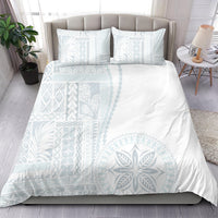 White duvet set with light-blue geometric and leaf siapo motifs, plus two pillowcases