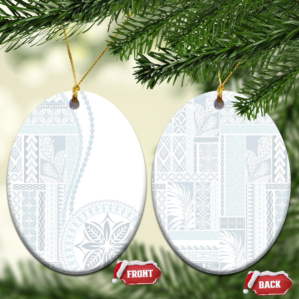 Pair of white ceramic oval ornaments with blue patterned siapo design hanging on gold cords.