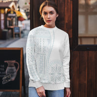 White crewneck sweater with light blue patterned yoke, long sleeves, ribbed hem.