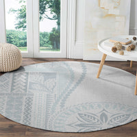 Round light-gray carpet with blue geometric panel and leaf motif detail
