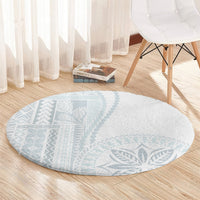 Round light-gray carpet with blue leaf medallion and soft flat weave