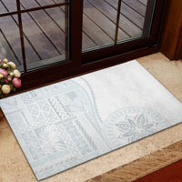 Rectangular rubber doormat with light blue traditional pattern on white surface