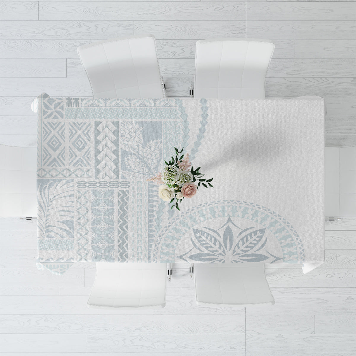 Light blue and white siapo-style tablecloth with geometric pattern and floral accent