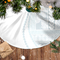 White circular tree skirt with light-blue patterned panels and a wide scalloped edge.