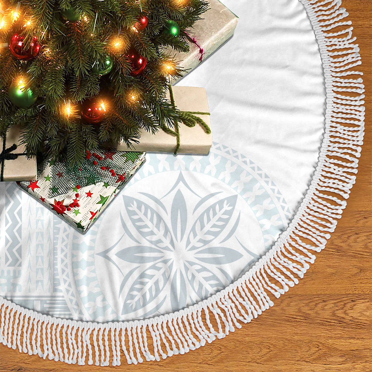 White tree skirt with light-blue pattern and braided fringe trim around the edge.