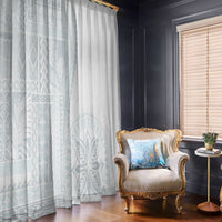 Pair of window curtains in white with light blue siapo-style patterns on left panel