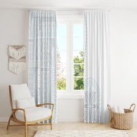 Hanging window curtains: white solid right panel and light blue siapo-style patterned left panel