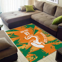 Rectangular orange and green area rug with central white elephant silhouette design