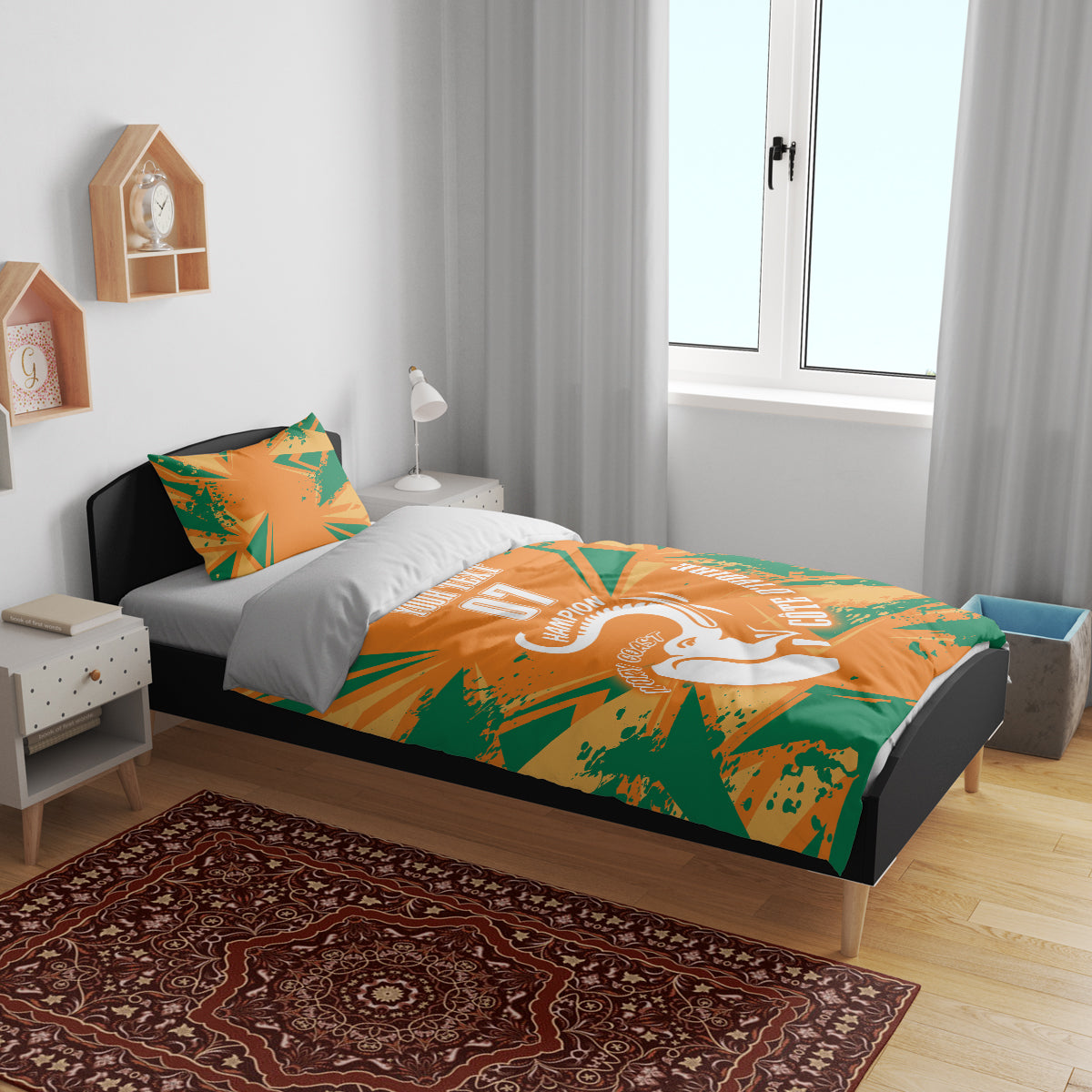 Orange and green geometric bedding set with elephant design on bed and two pillows