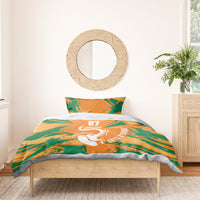 Orange and green geometric duvet and pillow set with elephant graphic in a bedroom