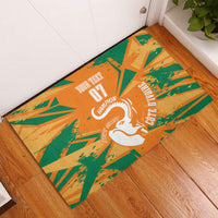 Orange rubber football doormat with green burst pattern and white elephant "07 Champion".