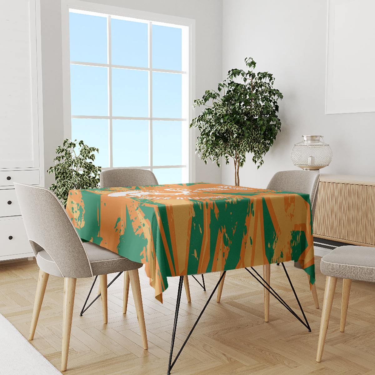 Orange and green elephant-themed custom tablecloth on a dining table