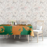 Orange and green elephant custom tablecloth covering a rectangular dining table