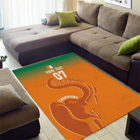 Orange rectangular area rug featuring an elephant graphic with sports lettering.