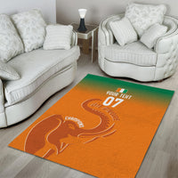 Orange rectangular area rug with elephant artwork and visible champions text.