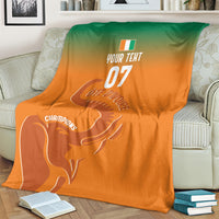 Custom football blanket on sofa with orange-to-green gradient, elephant and 07 text
