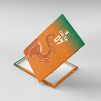 Orange canvas wall art angled on easel, elephant outline with '07' text.