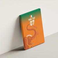 Orange canvas wall art tilted on wall, elephant silhouette and centered '07' number.