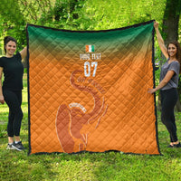 Orange and green diamond-quilted blanket with elephant outline and 'Champions' text