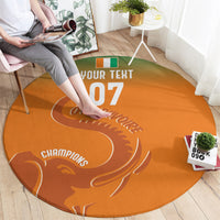 Round orange carpet with “YOUR TEXT 07” and “CHAMPIONS” white football swirl pattern