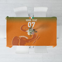 Orange custom tablecloth with football-style graphic and central emblem design