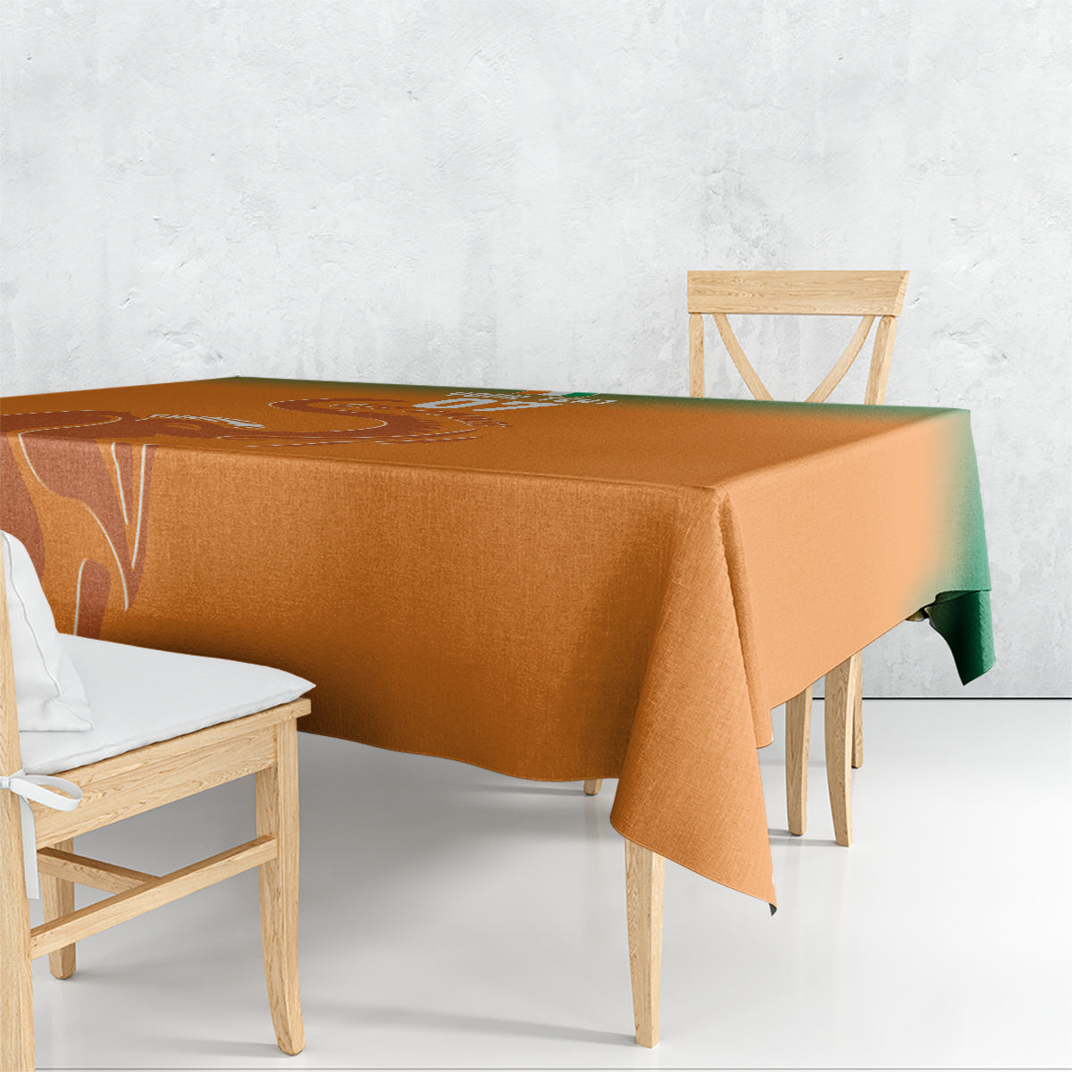 Orange tablecloth draped over dining table edge with printed sports-themed pattern
