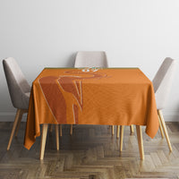 Orange rectangular tablecloth with sports-themed emblem centered over table