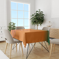 Orange tablecloth on dining table with printed sports emblem and decorative linework