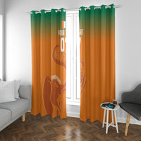 Orange window curtain with green top gradient and football elephant graphic, with grommets